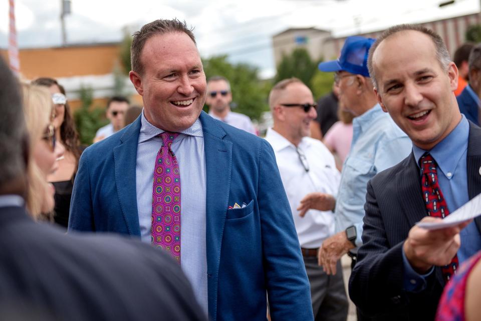 Pat Gillespie, of the Gillespie Group, left, mingles with the crowd including Mayor Andy Schor, right, during an event announcing the planned development of a grocery store and hotel at the 600 block of East Michigan Avenue on Wednesday, Aug. 29, 2018, in downtown Lansing. The project is part of a mixed-use developmentÊslated to open by theÊend of 2020.