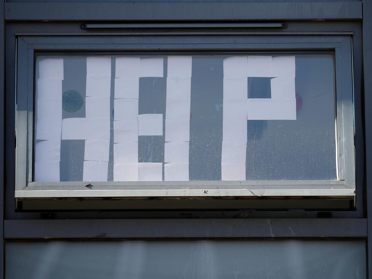 A 'Help' message is displayed at locked down student accommodation in Manchester (REUTERS)