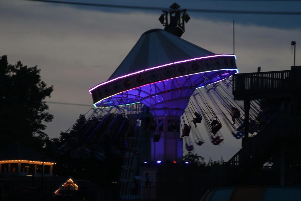 Patrons at Seabreeze Amusement Park are silhouetted against a sunset sky in Irondequoit. Sept. 5, 2016