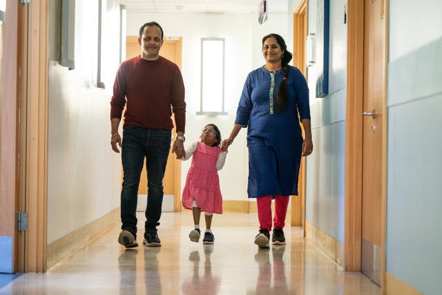 Aditi with her mother and father