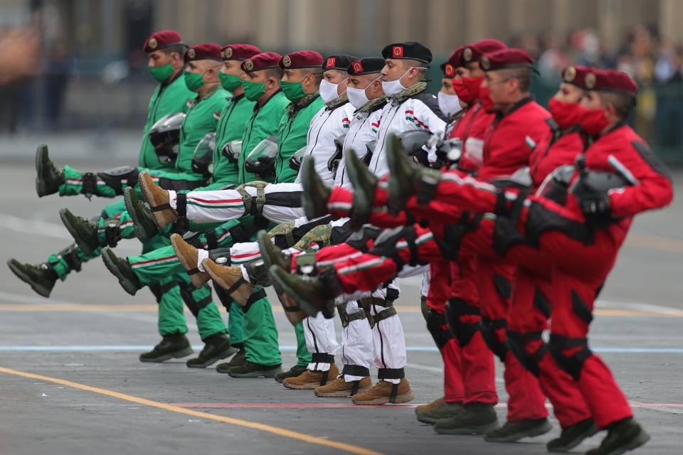 VARIOUS CITIES, MEXICO - SEPTEMBER 16: Parachuters of the Mexican army look up towards President Andrés Manuel López Obrador during the Independence Day military parade at Zocalo Square on September 16, 2020 in Various Cities, Mexico. This year El Zocalo remains closed for general public due to coronavirus restrictions. Every September 16 Mexico celebrates the beginning of the revolution uprising of 1810. (Photo by Hector Vivas/Getty Images)