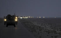 A line of Strykers convoy in the early hours of August 16, 2010 as part of the 4th Stryker Brigade Combat Team, 2nd Infantry Division, United States Division-Center?s last patrol through Iraq as they leave for Kuwait. Picture taken August 16, 2010. REUTERS/U.S. Army/Sgt. Kimberly Johnson/Handout