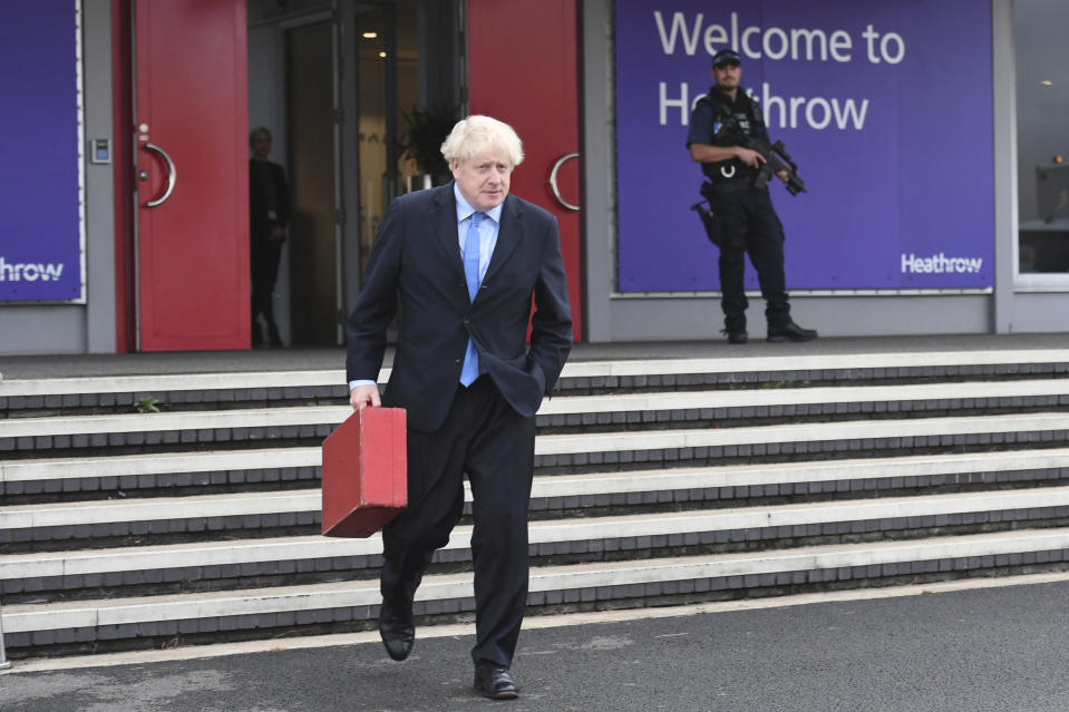 Britain's Prime Minister Boris Johnson walks to board his plane at London's Heathrow Airport as he heads off for the annual United Nations General Assembly in New York, Sunday Sept. 22, 2019. (Stefan Rousseau/PA via AP)