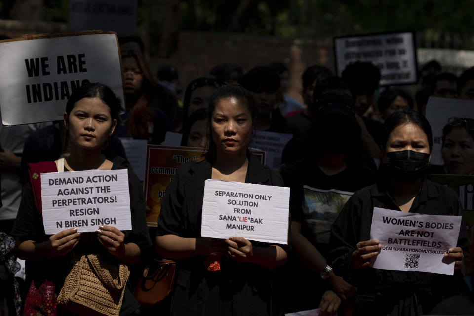 Protestors hold placards during a demonstration against deadly ethnic clashes in the country's northeastern state of Manipur, in New Delhi, India, Saturday, July, 22, 2023. Protests are being held across the country after a video showed a mob assaulting two women who were paraded naked. Thousands of people, mostly women, held a massive sit-in protest in India's violence-wracked northeastern state of Manipur state demanding immediate arrest of those involved in the harrowing assault. (AP Photo/Altaf Qadri)