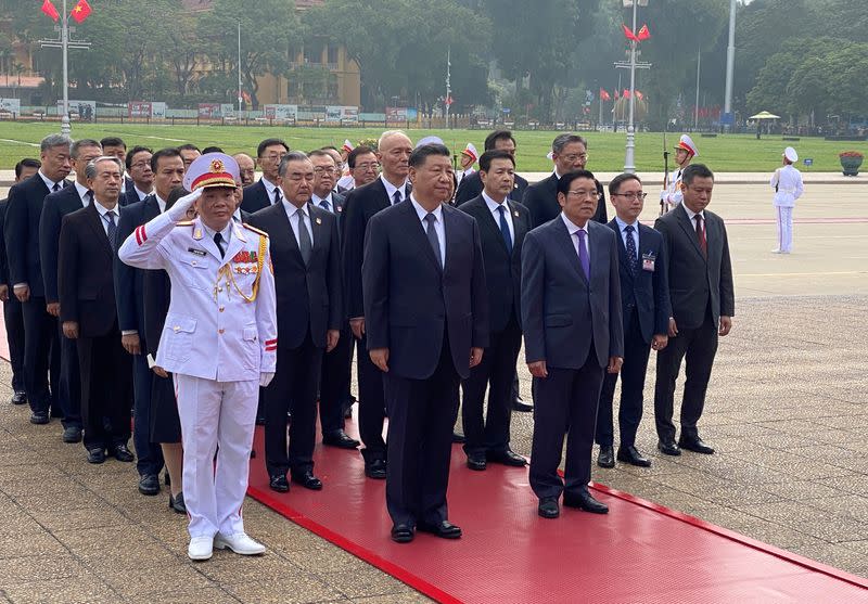 Chinese President Xi Jinping attends a lay wreath ceremony at the Ho Chi Minh mausoleum during a two day state visit to Hanoi