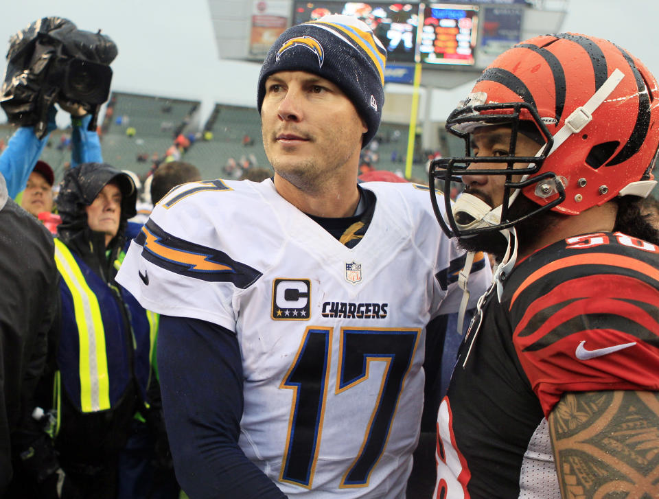 San Diego Chargers quarterback Philip Rivers (17) shakes hands with Cincinnati Bengals linebacker Rey Maualuga after a 27-10 win over the Bengals in an NFL wild-card playoff football game on Sunday, Jan. 5, 2014, in Cincinnati. (AP Photo/Tom Uhlman)