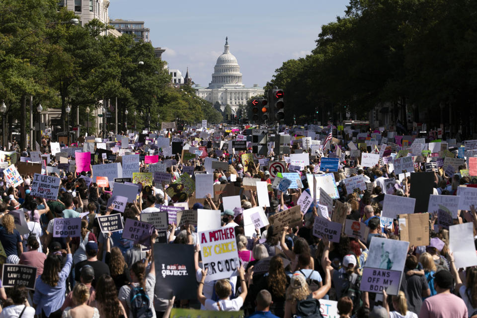 With the U.S Capitol in the background, thousands of demonstrators march on Pennsylvania Avenue during the Women's March in Washington, Saturday, Oct. 2, 2021. (AP Photo/Jose Luis Magana)