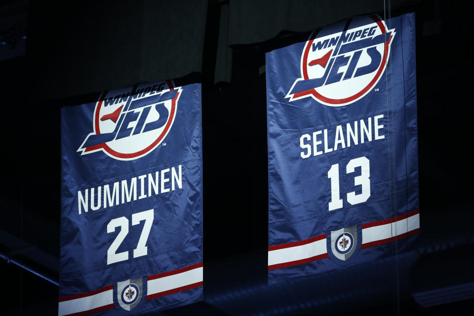 Former Winnipeg Jets' Teppo Numminen and Teemu Selanne are inducted into the Winnipeg Jets Hall of Fame during an unveiling ceremony prior to an NHL game against the Anaheim Ducks in Winnipeg, Manitoba, Thursday, Nov. 17, 2022. (John Woods/The Canadian Press via AP)