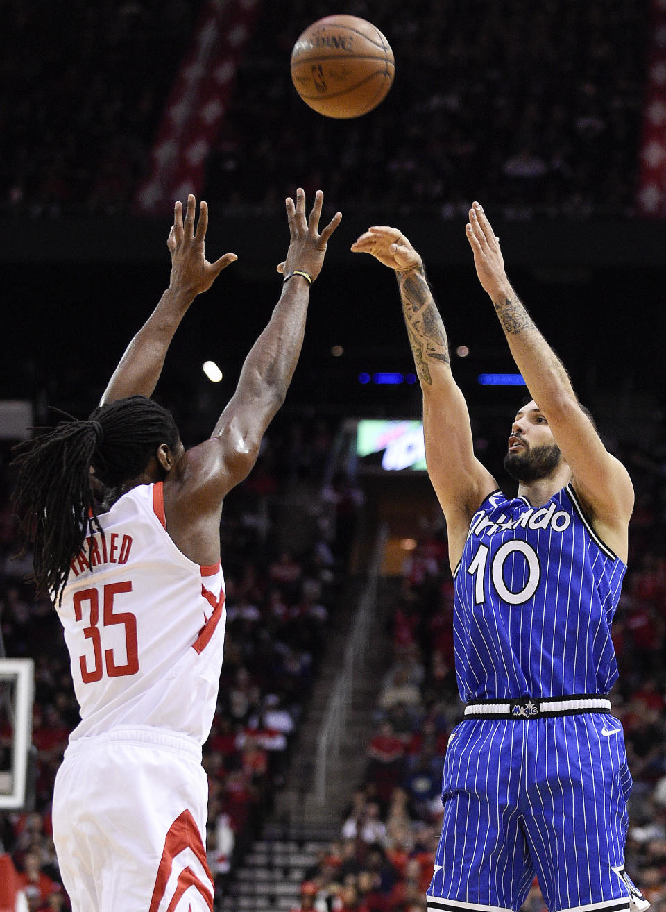 Orlando Magic guard Evan Fournier, right, shoots as Houston Rockets forward Kenneth Faried, left, defends during the first half of an NBA basketball game, Sunday, Jan. 27, 2019, in Houston. (AP Photo/Eric Christian Smith)