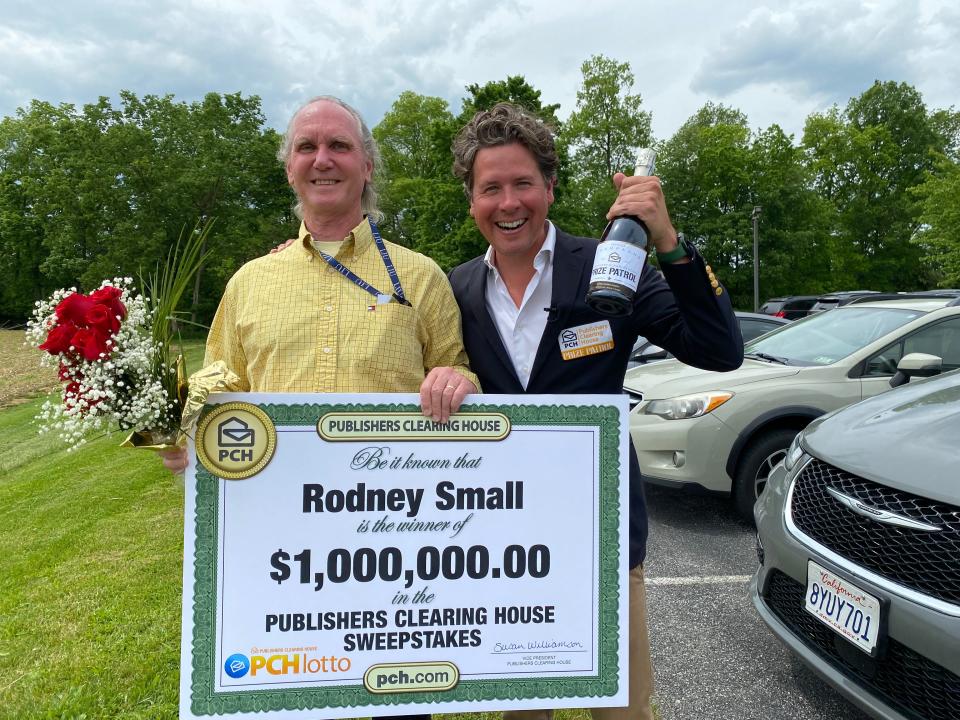 Rodney Small of Chambersburg, left, received a giant $1 million check, roses and champagne from Howie Guja of the Publishers Clearing House Prize Patrol on May 16.