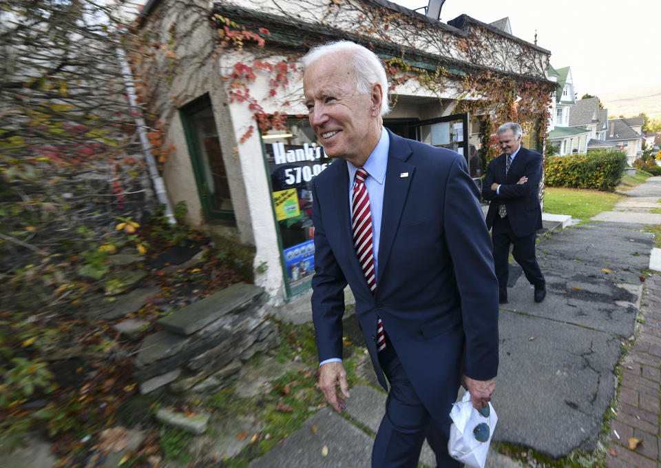 Former U.S. Vice President Joe Biden leaves Hank's Hogies with some treats after speaking at the Scranton Cultural Center in Scranton Pa., on Wednesday, Oct. 23, 2019. (Jason Farmer/The Times-Tribune via AP)