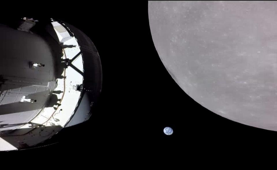 spaceship with moon looming large on the right and earth small in the distance beyond