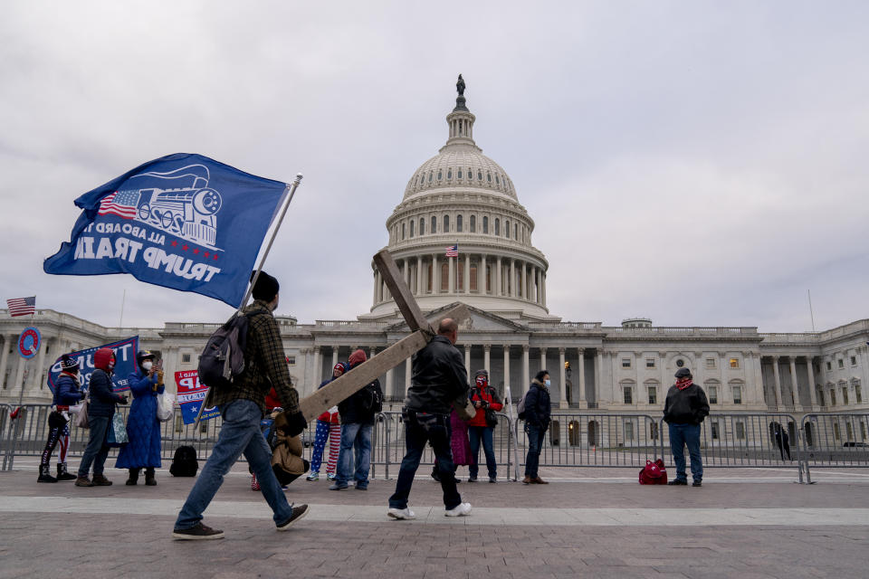 Demonstrators carry a cross to the U.S. Capitol in Washington, D.C., U.S., on Wednesday, Jan. 6, 2021. (Stefani Reynolds/Bloomberg via Getty Images)