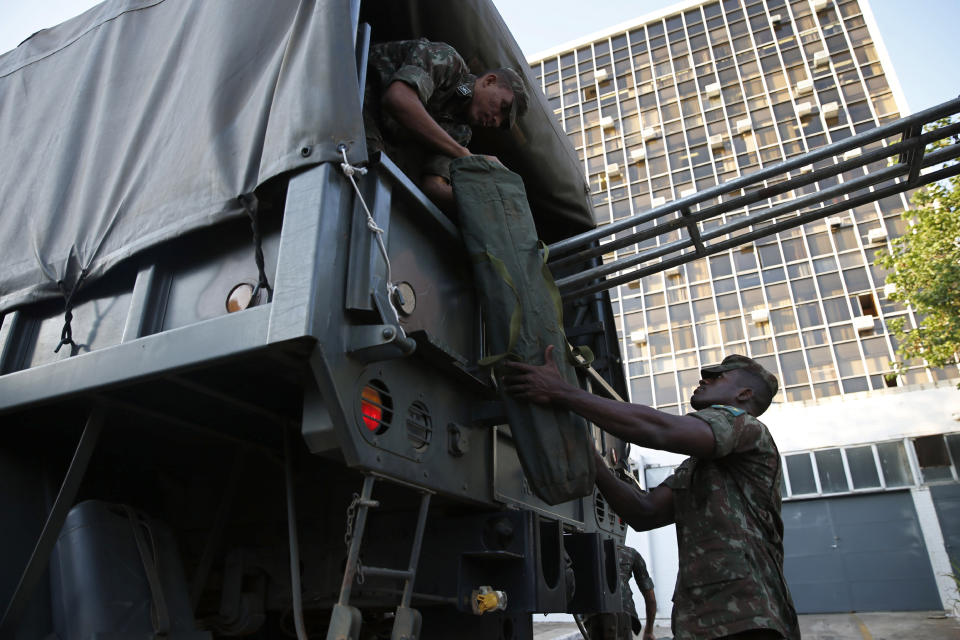 Brazilian army soldiers prepare a security base prior the 11th edition of the BRICS Summit, at the Itamaraty Palace in Brasilia, Brazil, Tuesday, Nov. 12, 2019. The BRICS Summit gathers the group of countries formed by Brazil, Russia, India, China and South Africa, which will take place in the 13th and 14th of this month. (AP Photo/Eraldo Peres)