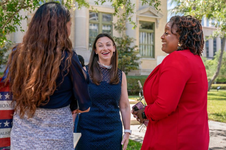 Commissioner of Agriculture and Consumer Services Nikki Fried speaks to Jenny Big Crow, left, and Marvelous Washington during a campaign stop as she runs for  governor in West Palm Beach, Florida on April 12, 2022.