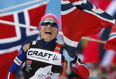 Therese Johaug of Norway celebrates as she crosses the finish line during the FIS Tour De Ski World Cup cross-country skiing women's 9km climb pursuit free final race on Alpe Cermis, in Val di Fiemme, Italy January 10, 2016. REUTERS/Alessandro Garofalo