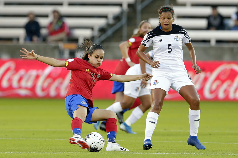 Costa Rica midfielder Katherine Alvarado, left, kicks away the ball in from of Panama defender Yerenis De Leon (5) during the first half of a women's Olympic qualifying soccer match Tuesday, Jan. 28, 2020, in Houston. (AP Photo/Michael Wyke)