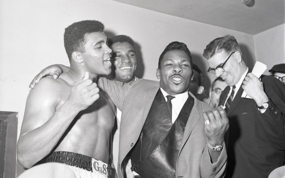 Lloyd Price, centre, joins Muhammed Ali – or, as he was then, Cassius Clay – for post-fight celebrations