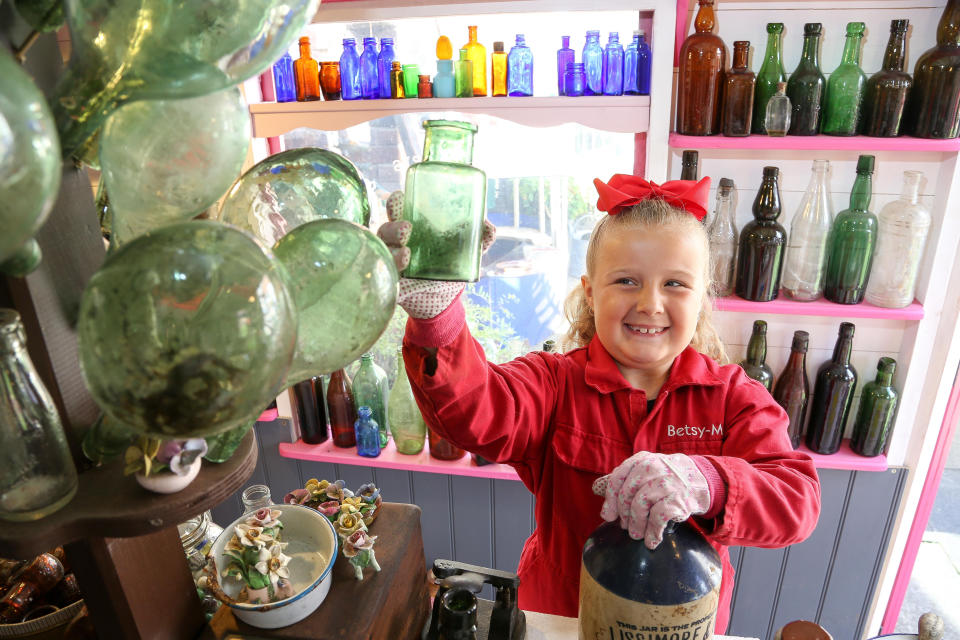 A seven-year-old schoolgirl is raking in hundreds of pounds by selling antique bottles from a little shop in her back garden - after digging them up from old landfill sites. Betsy-Mae Lloyd has been coining it in after launching her own business at her parents' home while still attending primary school.  The young entrepreneur flogs old bottles, jars and teapots - dating back to between the 1870s and 1930 - which she finds on historic landfill sites in the West Midlands.  After taking them home and cleaning them up herself, she then stores them in a Victorian-style play shed, built by dad Jason, before listing them for sale on Facebook. 