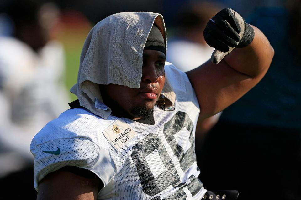 Jacksonville Jaguars defensive end Jeremiah Ledbetter (99) keeps cool while stretching Tuesday, Aug. 1, 2023 at Miller Electric Center at EverBank Stadium in Jacksonville, Fla. Today marked the first padded practice. 