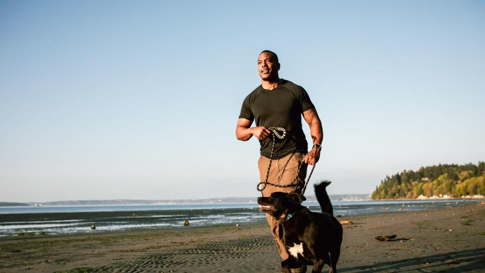 Man walking on beach with dog