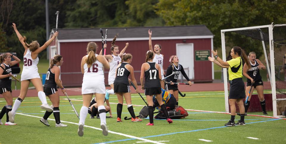 Members of the Portsmouth High School field hockey team celebrate Sydney Moreau’s goal late in regulation in Friday's Division II field hockey game.