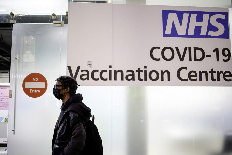 LONDON, UNITED KINGDOM - 2021/12/14: A person wearing a facial mask walks past the NHS COVID-19 vaccination centre at Westfield Stratford.
British government urges citizens to get their booster dose in view of the quick spread of the omicron variant in the UK. (Photo by Hesther Ng/SOPA Images/LightRocket via Getty Images)