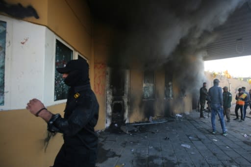 Smoke billows from the entrance of the US embassy in Baghdad after pro-Iran protesters tried to break into the building during a rally to vent anger over deadly US air strikes