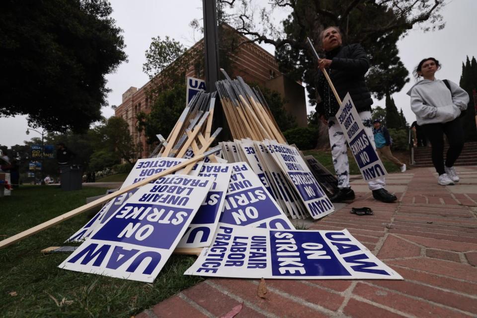 A pile of picket signs reading "UAW On Strike."