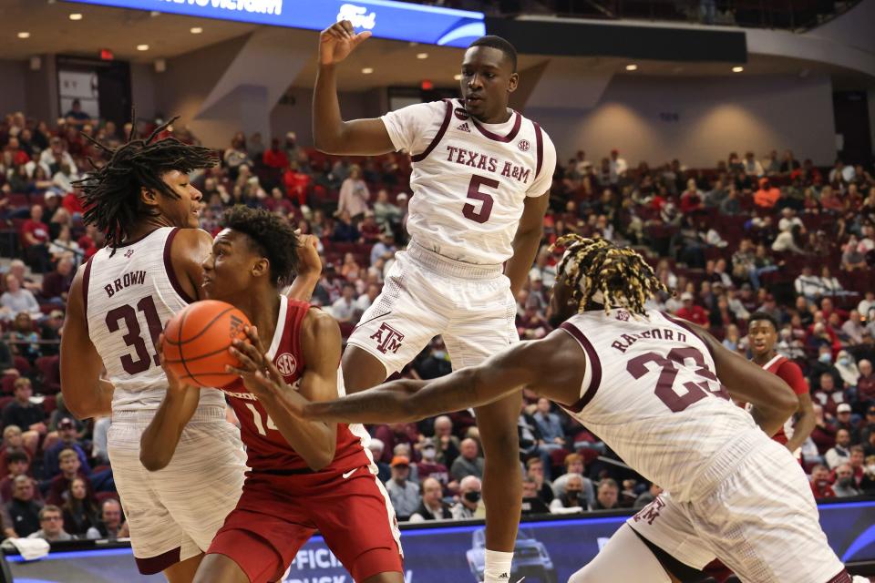 Jan 8, 2022; College Station, Texas, USA; Arkansas Razorbacks guard Jaxson Robinson (14) is fouled by Texas A&M Aggies guard Tyrece Radford (23) in the first half at Reed Arena. Mandatory Credit: Thomas Shea-USA TODAY Sports