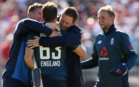 Jos Buttler is embraced by England captain Eoin Morgan after his match-winning innings - Credit: AFP