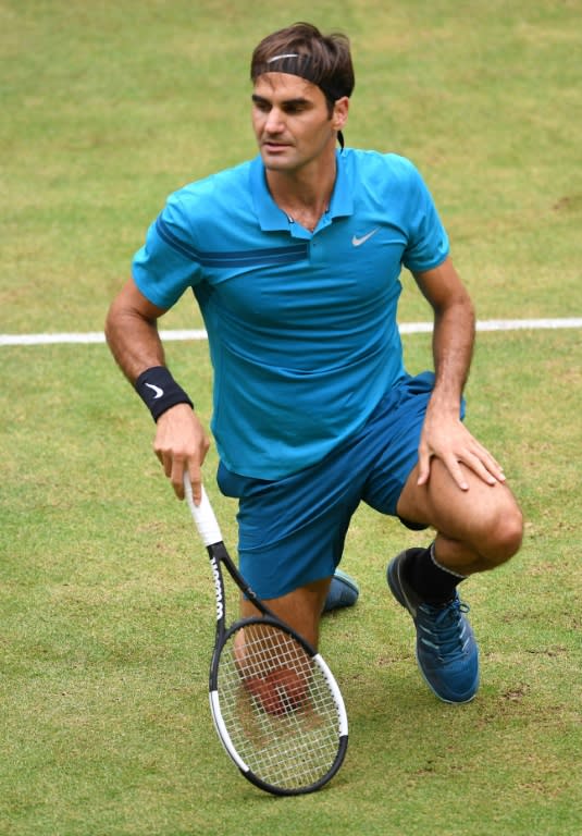 Down and out: Roger Federer on his way to defeat against Borna Coric in Halle on Sunday