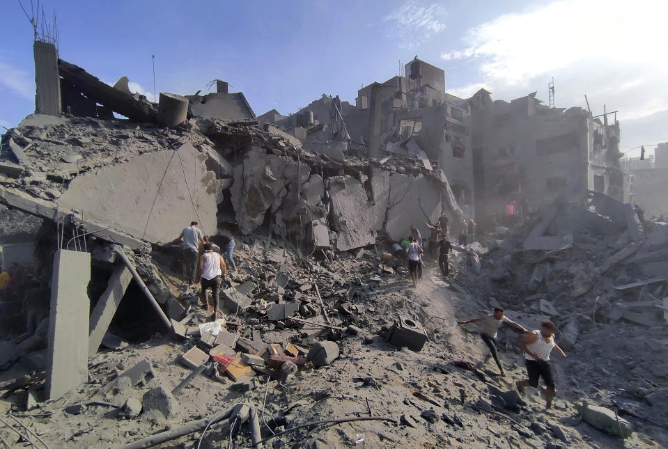 Palestinians inspect the damage of buildings destroyed by Israeli airstrikes on Jabaliya refugee camp on the outskirts of Gaza City, Tuesday, Oct. 31, 2023 (AP Photo/Abdul Qader Sabbah)