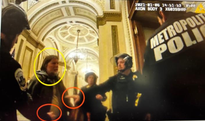 Howard B. Adams of Edgewater (circled in yellow) is told to back away from door by police during Jan. 6, 2021 riot at the Capitol.