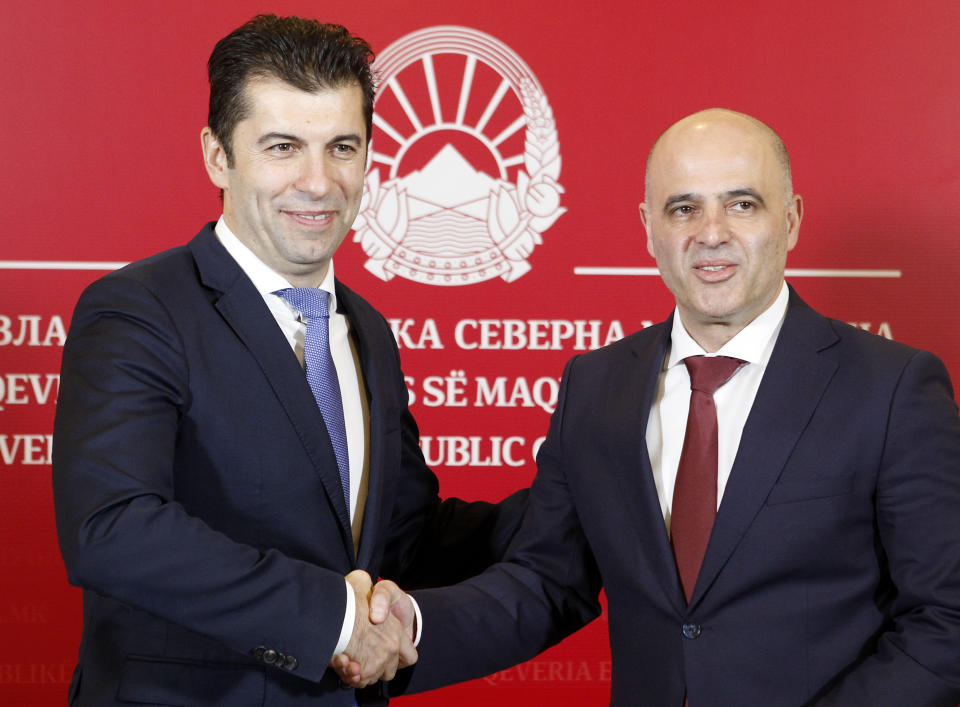 Bulgaria's Prime Minister Kiril Petkov, left, and North Macedonia's Prime Minister Dimitar Kovacevski, right, shake hands during the news conference after their talks, in the government building in Skopje, North Macedonia, Tuesday, Jan. 18, 2022. Bulgarian Prime minister Kiril Petkov was visiting North Macedonia Tuesday in a bid to improve ties between two Balkan neighbors strained with Sofia's veto for Skopje's strive to start membership talks with European Union. (AP Photo/Boris Grdanoski)