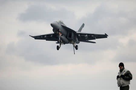 A U.S. F18 fighter jet approaches the deck of U.S. aircraft carrier USS Carl Vinson during an annual joint military exercise called "Foal Eagle" between South Korea and U.S., in the East Sea, South Korea, March 14, 2017. REUTERS/Kim Hong-Ji