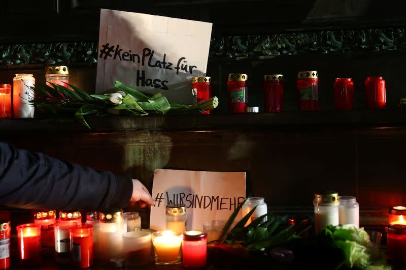 People attend a vigil for the victims of a shooting in Hanau