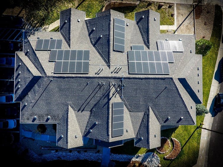 A bird's eye view of a roof with solar panels