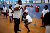 Teacher Alan (L) trains children during an exercise session at a boxing school, in the Mare favela of Rio de Janeiro, Brazil, June 2, 2016. REUTERS/Nacho Doce