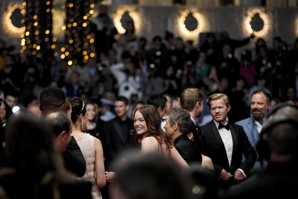 Emma Stone, centro, posa para retratos al salir de la premiere de 'Kinds of Kindness' en la en 77a edición del Festival de Cine de Cannes en Francia, el viernes 17 de mayo de 2024. (Foto Andreea Alexandru/Invision/AP)