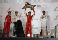 Formula 1 F1 - Bahrain Grand Prix - Bahrain International Circuit, Sakhir, Bahrain - April 8, 2018 Ferrari's Sebastian Vettel celebrates with the trophy as Mercedes' Lewis Hamilton and Mercedes' Valtteri Bottas look on after the race REUTERS/Ahmed Jadallah