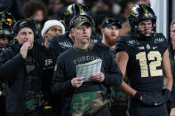 Purdue head coach Jeff Brohm, center, watches from the sideline during the second half of an NCAA college football game against Michigan State in West Lafayette, Ind., Saturday, Nov. 6, 2021. (AP Photo/Michael Conroy)