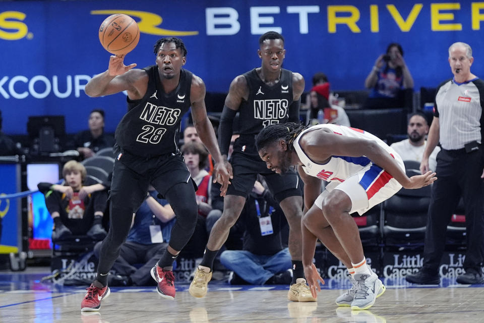 Detroit Pistons center Isaiah Stewart loses control of the ball to Brooklyn Nets forward Dorian Finney-Smith (28) during the first half of an NBA basketball game, Thursday, March 7, 2024, in Detroit. (AP Photo/Carlos Osorio)