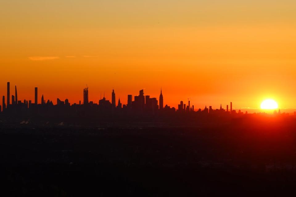 The sun rises over midtown Manhattan in a view from West Orange, New Jersey (AFP via Getty Images)