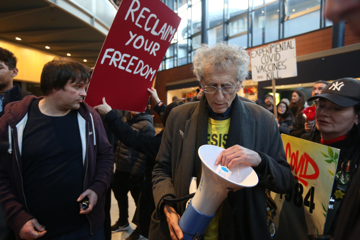 MILTON KEYNES, ENGLAND - DECEMBER 29: Piers Corbyn and protesters forcibly enter the theatre to protest against cashless transactions and vaccine passports joined by Piers Corbyn on December 29, 2021 in Milton Keynes, England. Protesters are demonstrating against further Covid restrictions and perceived medical apartheid with a march to Milton Keynes main shopping centre. (Photo by Martin Pope/Getty Images)