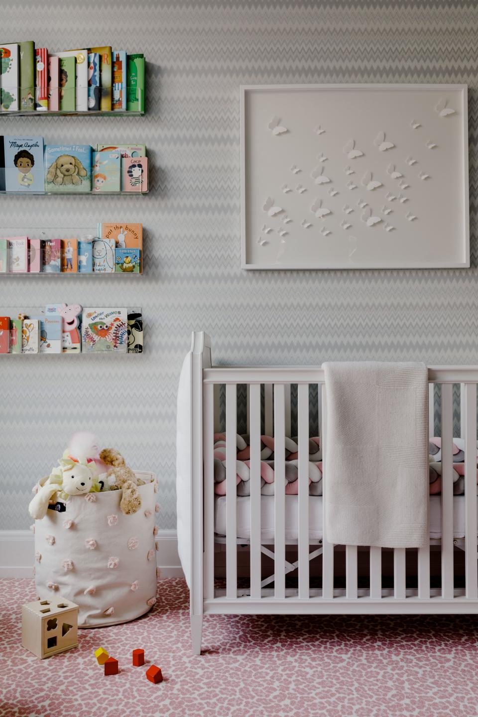 Younger daughter Esme’s room was done mostly in a palette of grays and whites, with a pop of color in the leopard-print carpet. The crib and painting are both from Restoration Hardware.