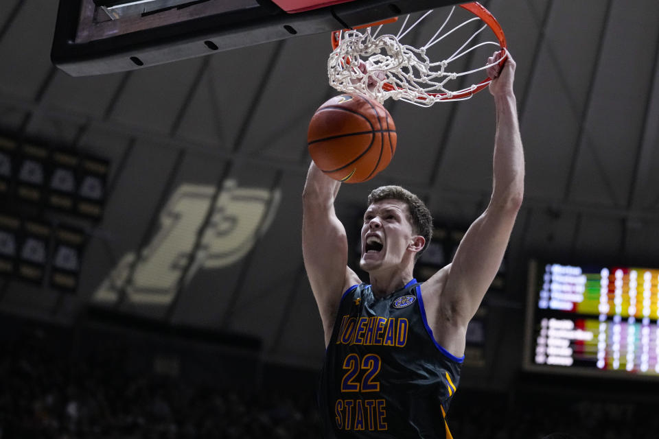 FILE - Morehead State guard Riley Minix (22) gets a basket on a dunk against Purdue during the first half of an NCAA college basketball game in West Lafayette, Ind., Friday, Nov. 10, 2023. This 6-7 graduate student was the Ohio Valley Conference player of the year at Morehead State after transferring from NAIA program Southeastern (Florida). (AP Photo/Michael Conroy, File)