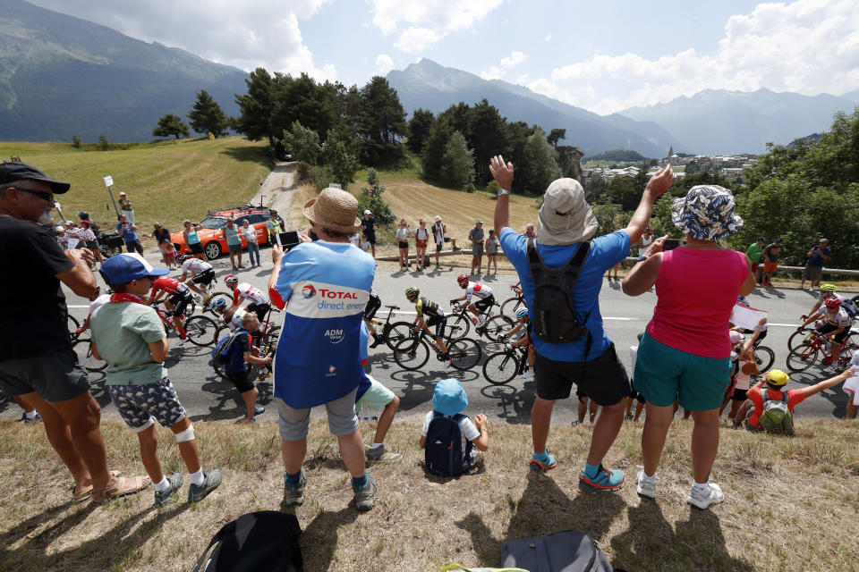 Spectators along the road applaud the riders during the nineteenth stage of the Tour de France cycling race over 126,5 kilometers (78,60 miles) with start in Saint Jean De Maurienne and finish in Tignes, France, Friday, July 26, 2019. (AP Photo/Thibault Camus)
