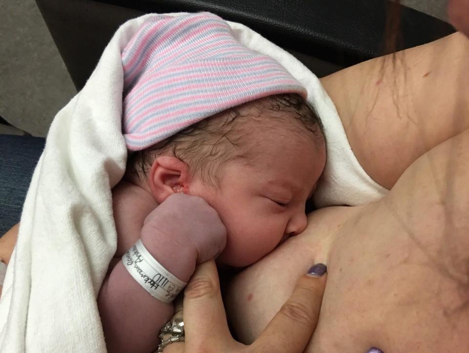 Mia Hockman, a newborn, breastfeeds from her mother, Bekki.