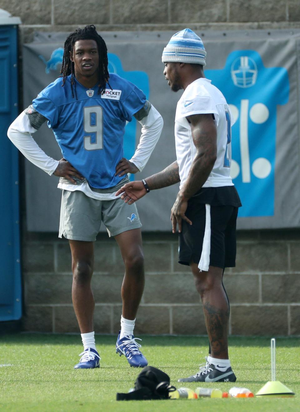 Detroit Lions wide receiver Jameson Williams (9) and safety C.J. Gardner-Johnson (2) talk during training camp at team headquarters in Allen Park on Friday, July 28, 2023.